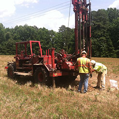 Workers inspecting construction vehicle