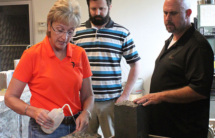 Falcon President Margaret Robertson trains staff on flexural testing of concrete beam specimens.